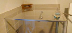 Shower cubicle with perspex resting on top