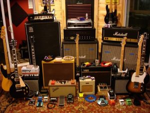 Arrangement of guitars, amplifiers and effects pedals in a room