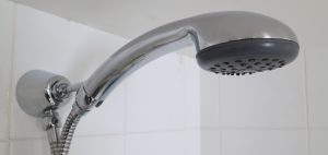 Water saving showerhead installed in shower cubicle