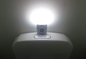 Battery powered night light on toilet cistern