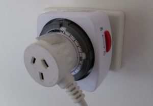 Appliance plugged into electric wall timer