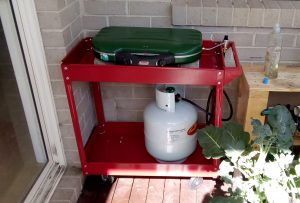 Outdoor stove and LPG bottle under a pergola