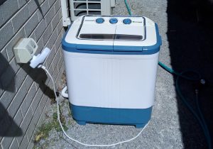 Portable washing machine plugged in with energy monitor