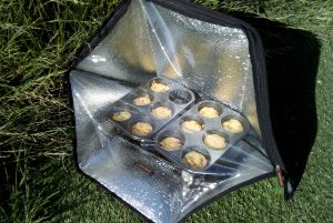 Solar oven in sun with muffin tray inside